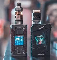 Two vaping devices with digital displays on a blurred background